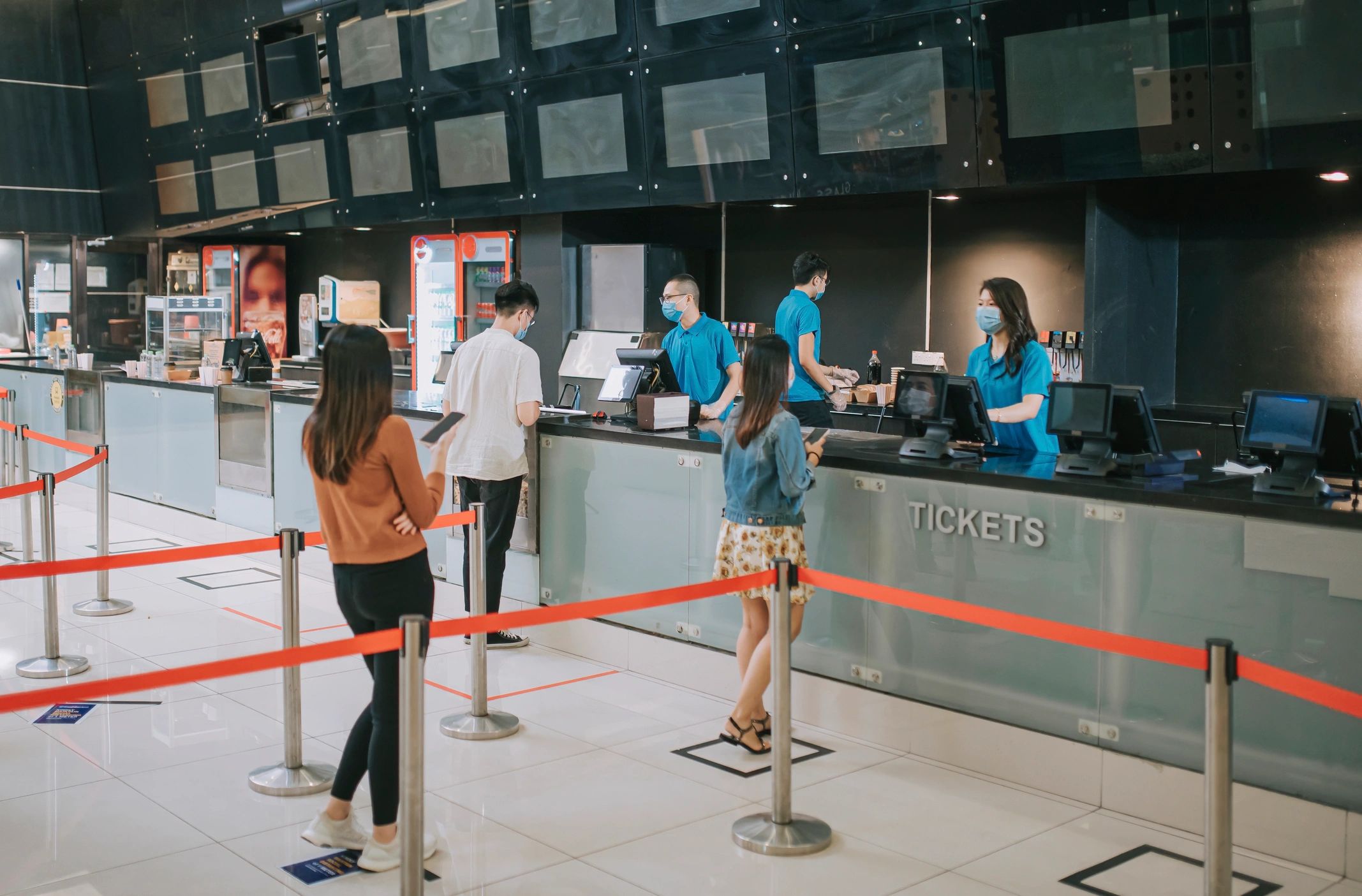 Moviegoers at a cinema ticket area