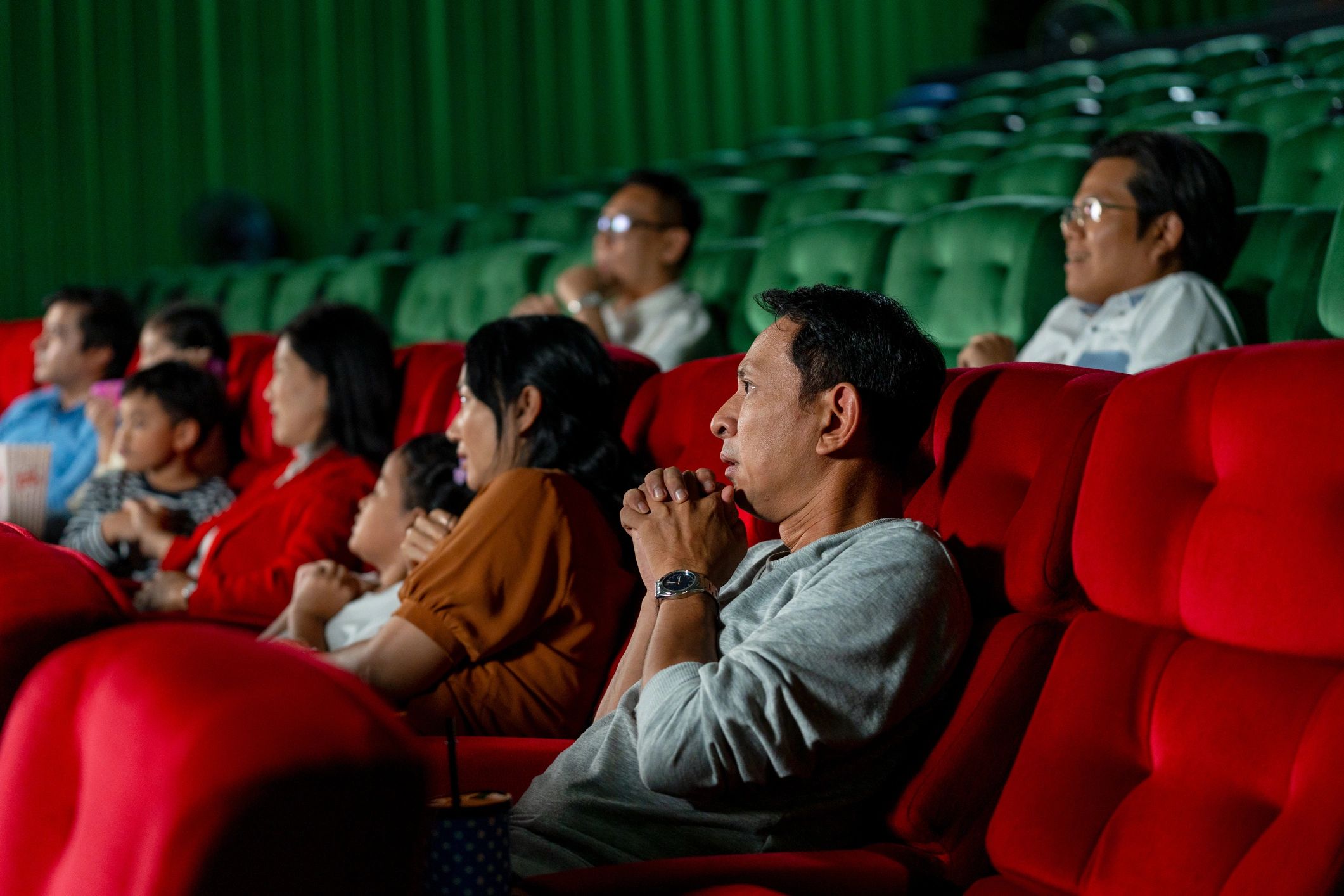Audience reacting during a movie screening in a theater