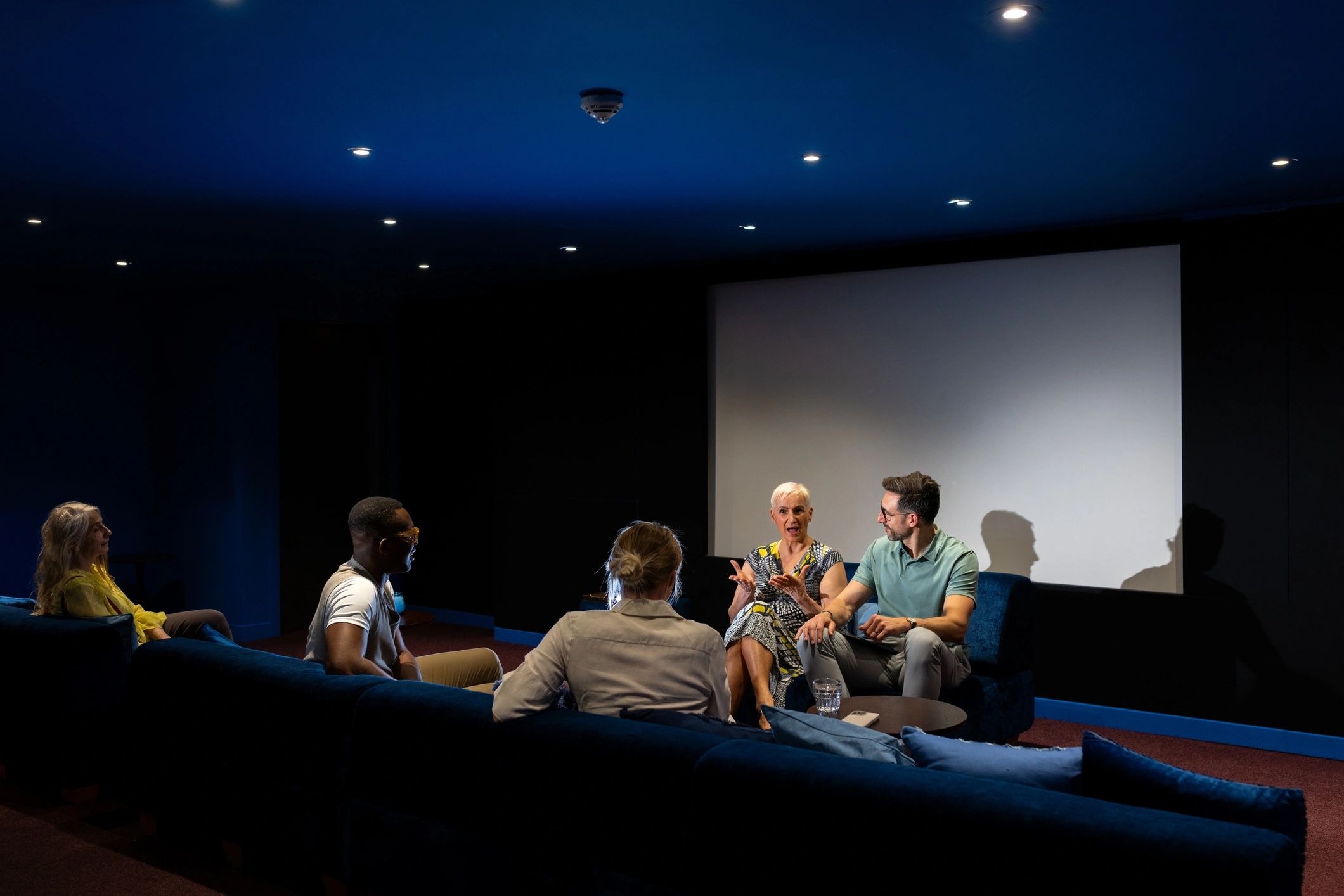Audience gathered in a stylish dark theater space